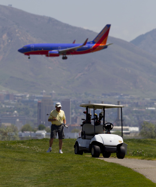 Trent Nelson  |  The Salt Lake Tribune
A Southwest Airlines jet flies over golfer Bob Newsom at Salt Lake City's Wingpointe golf course Wednesday, May 2, 2012.  A demand from the FAA could cause a dramatic increase in Wingpointe's lease.