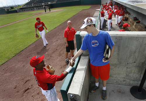 Scott Sommerdorf   |  The Salt Lake Tribune
Owlz infielder talks with Owlz fan Riley Lundrigan near the Owlz dugout prior to the Orem Owlz game versus the Billings Mustangs, Sunday, July 14, 2013. The low key and relaxed atmosphere at this level of play allows for more direct contact with players.