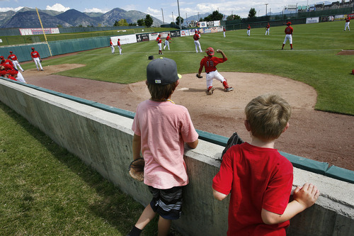 Scott Sommerdorf   |  The Salt Lake Tribune
Brothers Keegan, left, and Kanyon Jonas of Draper watch Owlz players warm up from the grassy fan's area close to the Owlz bullpen prior to the Owlz game versus the Billings Mustangs, Sunday, July 14, 2013.