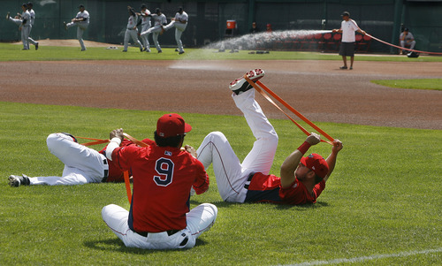Scott Sommerdorf   |  The Salt Lake Tribune
As a conga line of Billings Mustangs stretch in the outfield, Owlz players do their own stretching routine in the foreground prior to gametime in Orem, Sunday, July 14, 2013.