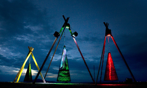 Rick Egan  | The Salt Lake Tribune 

The art installation "3" by Josh Epperson glows  at the Element11 Arts Festival at Bonneville Seabase, Thursday, July 11, 2013. The installation consists of tall metal pyramids with patterns and colors that change at as they sway in the wind.