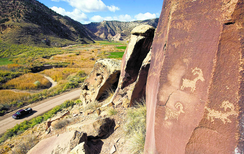 Al Hartmann  |  Salt Lake Tribune  
A truck makes its way along dirt road in Nine Mile Canyon.  Just above the road are hundreds of examples of rock art like these.  The Bill Barrett Corporation was one of seven signatories to the Probrammatic Agreement for Archaelogical Rescources in Nine Mile Canyon.  The coorportation operates many gas wells in the area and have agreed to fund cultural rescources fieldwork monitoring, rock art conservation and mitigation plans like dust suppression to help preserve the rock art.