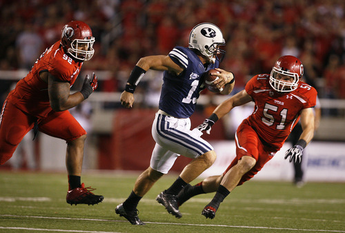 Scott Sommerdorf  |  The Salt Lake Tribune             
BYU quarterback Riley Nelson is chased by Utah defensive tackle Star Lotulelei (92), left, and  linebacker Dave Fagergren (51) after flushing him out of the pocket during first-half play on Saturday, Sept. 15, 2012.