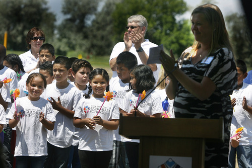 Scott Sommerdorf  |  The Salt Lake Tribune
Guadalupe School students applaude on Thursday after Ellen Rossi, right, announced the Janet Q. Lawson Foundation 2 million dollar grant to help build the new Guadalupe School. Later the students formed a human chain to delineate the new building's perimeter. This ties to the event's theme "Staking our Future: A New Building. A New Hope."