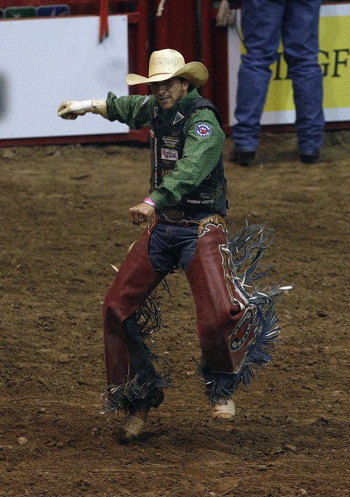 Scott Sommerdorf   |  The Salt Lake Tribune
JW Harris does a little dance after he rode "Bush Baby" to an 78 point ride to put him at 4th in the Bullriding competition in The Days of '47 Rodeo at EnergySolutions Arena, Friday, July 19, 2013.