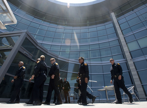 Steve Griffin | The Salt Lake Tribune

Salt Lake City police officers enter the new Public Safety Building after a ribbon-cutting ceremony Friday July 19, 2013.