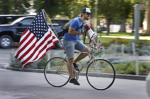 Scott Sommerdorf   |  The Salt Lake Tribune
Jack Lasley rides around announcing the Bicycle Ambassadors' July ride with the theme "MERICA" in Salt Lake City, Saturday, July 13, 2013.