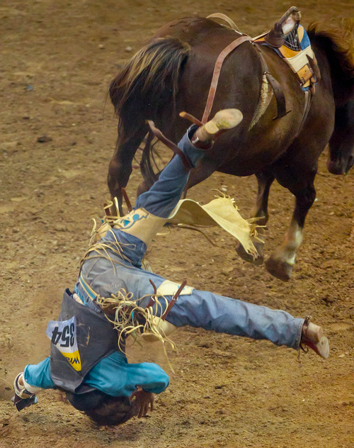 Trent Nelson  |  The Salt Lake Tribune
Tyler Scales is thrown while competing in Championship Bareback Riding at the Days of '47 Rodeo at EnergySolutions Arena in Salt Lake City Saturday July 20, 2013.