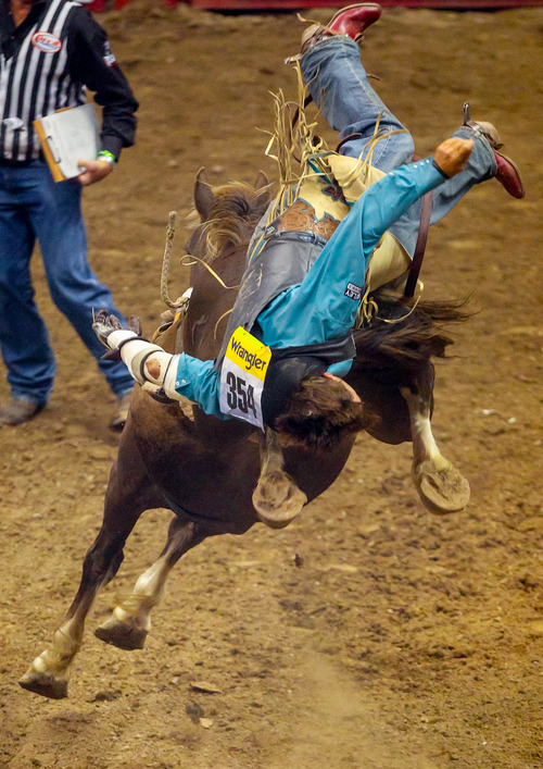 Trent Nelson  |  The Salt Lake Tribune
Tyler Scales is thrown while competing in Championship Bareback Riding at the Days of '47 Rodeo at EnergySolutions Arena in Salt Lake City Saturday July 20, 2013.