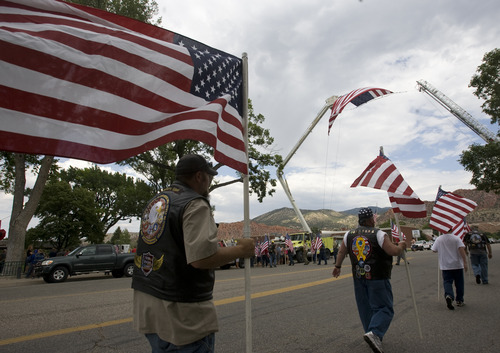 Rick Egan  |  The Salt Lake Tribune 
Members of the Patriot Guard Riders carry flags at the benefit picnic at Cedar City Park on Main Street, Saturday, July 20, 2013. The event is to honor and raise money for Joe Thurston, a Cedar City native and Hotshot firefighter who died in the Arizona wildfire last month.