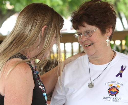 Rick Egan  | The Salt Lake Tribune 
Janis Hammond, left, greets Gayemarie Erker, the mother of Joe Thurston, at the benefit picnic at Cedar City Park on Main Street, Saturday, July 20, 2013. The event is to honor and raise money for Thurston, a Cedar City native and Hotshot firefighter who died in the Arizona wildfire last month.