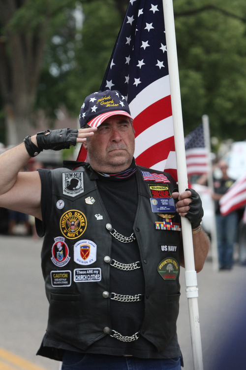 Rick Egan  |  The Salt Lake Tribune 
Stephen Meyer, with the Patriot Guard Riders, salutes as he holds a flag at the benefit picnic at Cedar City Park on Main Street on Saturday. The event is to honor and raise money for Joe Thurston, a Cedar City native and Hotshot firefighter who died in the Arizona wildfire last month.