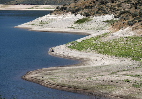 Al Hartmann  |  The Salt Lake Tribune
Exposed beach at water's edge show the receding water level of East Canyon Reservoir on July 19.   Low snowpack from last winter is impacting water levels at Utah's lakes and reservoirs affecting boating and fishing.