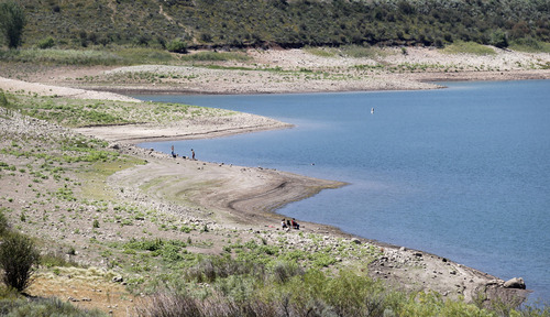 Al Hartmann  |  The Salt Lake Tribune
Exposed beach at water's edge show the receding water level of East Canyon Reservoir on July 19.   Low snowpack from last winter is impacting water levels at Utah's lake and reservoirs affecting boating and fishing.