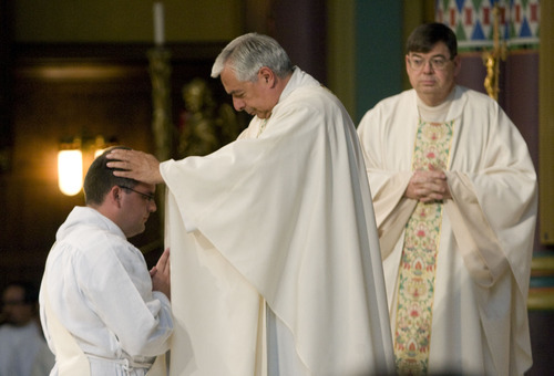 Kim Raff  |  The Salt Lake Tribune
Monsignor Joseph M. Mayo (middle), rector of The Cathedral of the Madeleine blesses the Rev. Christopher Gray (left) during Gray's ordination as a priest at the Cathedral of the Madeleine in Salt Lake City on June 29, 2013.