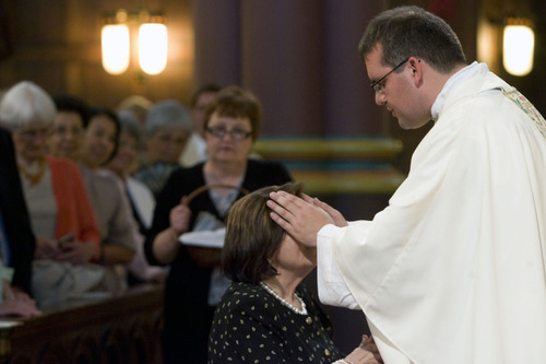 Kim Raff  |  The Salt Lake Tribune
The Rev. Christopher Gray (right) gives a blessing to his mother Maria de la Cruz after Gray's ordination ceremony as a priest at the Cathedral of the Madeleine in Salt Lake City on June 29, 2013.