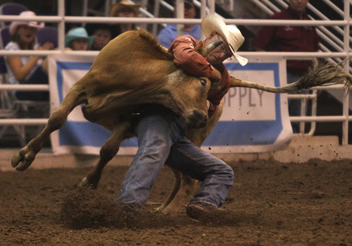 Rick Egan  | The Salt Lake Tribune 

Matt Reeves, Cross Plains, TX, competes in the Steer Wrestling competition, in the Days of '47 Rodeo, at EnergySolutions Arena, Monday, July 22, 2013.