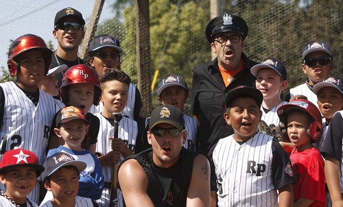 Leah Hogsten  |  The Salt Lake Tribune
l-r "The Sandlot" actor Daniel Zacapa (Police Chief) poses for pictures and has everyone say "Forever". The Salt Lake Bees baseball players conducted a morning clinic with Glendale and Rose Park area kids on original sandlot field, Saturday, July 20, 2013 for the 20th anniversary of "The Sandlot," the classic baseball movie filmed primarily in Utah.
