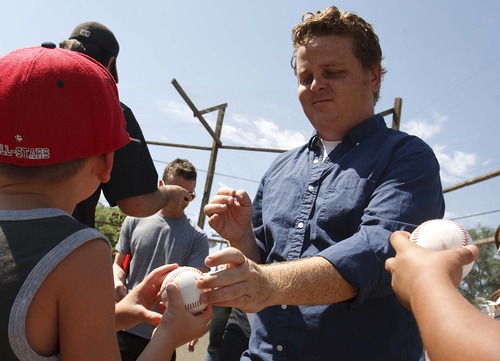 Leah Hogsten  |  The Salt Lake Tribune
"The Sandlot" actor Patrick Renna, who played Hamilton "Ham" Porter signs baseballs for the kids. The Salt Lake Bees baseball players conducted a morning clinic on Saturday with Glendale and Rose Park area kids on original sandlot field.