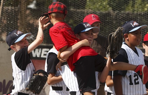 Leah Hogsten  |  The Salt Lake Tribune
Rose Park Cal Ripken Little League All Star players react during the game. The Salt Lake Bees baseball players conducted a morning clinic with Glendale and Rose Park area kids on original sandlot field, Saturday, July 20, 2013 for the 20th anniversary of "The Sandlot," the classic baseball movie filmed primarily in Utah.