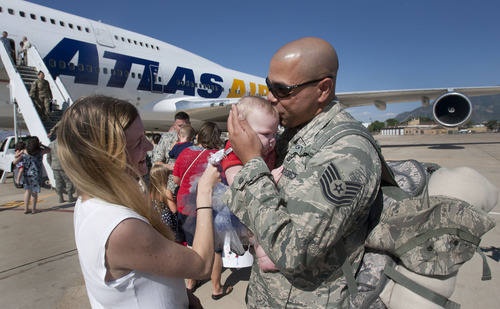 Steve Griffin | The Salt Lake Tribune


After a six-month tour of duty in Southwest Asia, John Croston, holds his daughter, Emily, 5 months, and kisses her for the first time in Ogden, Utah Sunday July 21, 2013. Croston was met on the tarmac by his wife, Rachel, and new born daughter after returning with the 729th Air Control Squadron (Angry Warriors). He had not seen Emily before that moment. The unit provided radar air surveillance and command and control of coalition aircraft over the Afghanistan. The squadron controlled more than 255,000 square miles of Afghani airspace, providing support for more than 34,000 air combat sorties.