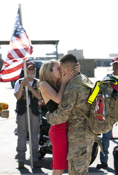 Steve Griffin | The Salt Lake Tribune

On the HIll Air Force Base tarmac moments after arriving back in the United States, Anthony O'Conner kisses Laura Boyce after proposing to her in Ogden Sunday July 21, 2013. He returned with the 729th Air Control Squadron (Angry Warriors) after a six-month tour of duty in Southwest Asia. The unit provided radar air surveillance and command and control of coalition aircraft over the Afghanistan. The squadron controlled more than 255,000 square miles of Afghani airspace, providing support for more than 34,000 air combat sorties. Boyce said yes.