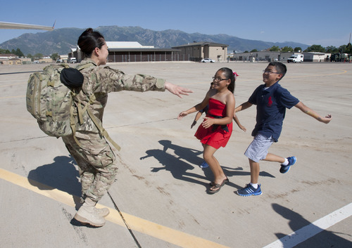Steve Griffin | The Salt Lake Tribune

Leno Hall-Hosino holds her arms out as her children, Jackson, back, Madison and Justin race into her arms on the tarmac at Hill Air Force Base in Ogden Sunday July 21, 2013. Hall-Hosino returned with the 729th Air Control Squadron (Angry Warriors) after a six-month tour of duty in Southwest Asia. The unit provided radar air surveillance and command and control of coalition aircraft over the Afghanistan. The squadron controlled more than 255,000 square miles of Afghani airspace, providing support for more than 34,000 air combat sorties.