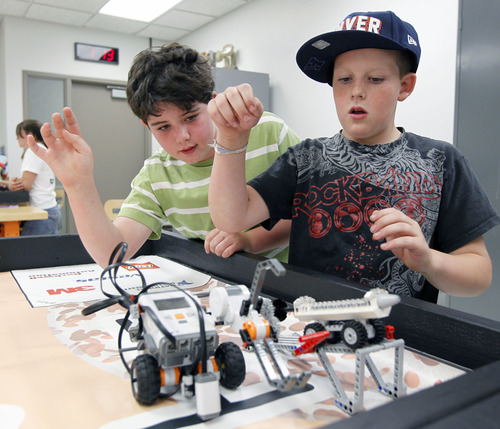 Al Hartmann  |  The Salt Lake Tribune
Gray Fitzpatrick, 9, left, and Carter Doncouse watch their programmable robot do a task for "First Lego League" at the University of Utah Computer Science GREAT camp. Teachers and computer professionals now liken computer science to a learning a language. They say that to date, students are required to make the equivalent of small talk, but they should be trained to speak fluently, and that means learning to program computers.