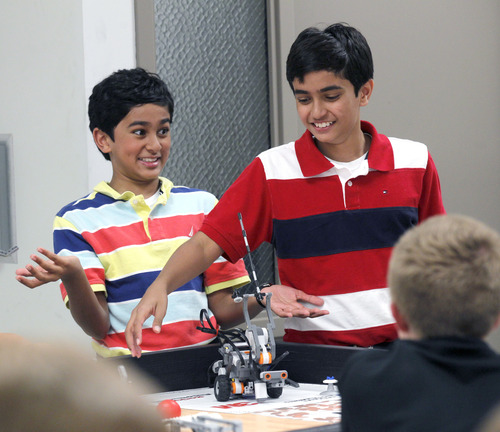 Al Hartmann  |  The Salt Lake Tribune
Twins Vikrant and Kanishka Ragula, 12, react as their robot completes a move they programmed for "First Lego League" at the University of Utah camp. The camp has grown from 30 students to 500 in the past five years. It demonstrates an uptick in the number of children and families interested in computer programming.