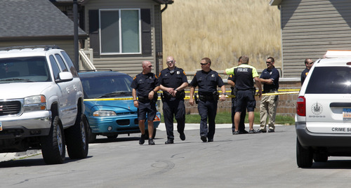 Al Hartmann  |  The Salt Lake Tribune
Salt Lake City police investigate a crime scene at 1658 W. 225 South where two bodies were found Monday afternoon July 22. One person was found in a car and the other was nearby in the street.