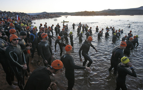 Competitors head into the water at 6:45 a.m. to swim the first leg of the Ironman in Sand Hollow Reservoir near St. George on May 1.  1,915 competitors from 30 countries and 47 states began a 2.4-mile swim in the 59-degree water.  Rick Egan/The Salt Lake Tribune