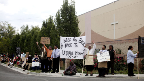 Tribune file photo
Members of the Tongan United Methodist Church in West Valley City protest the temporary removal of their pastor, Rev. Havili Mone, outside the church Sept. 23, 2012. Mone's permanent removal without explanation two months later, led to a schism and the formation of another church.