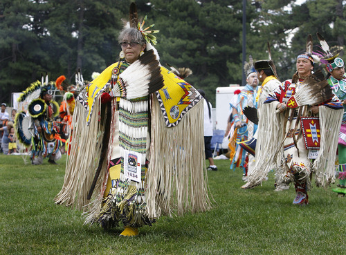 Scott Sommerdorf   |  The Salt Lake Tribune
Lita Mathews takes part in the opening procession at the Native American celebration in the Park, the annual Pioneer Day event celebrating American Indian culture. the grand entry of dancers, Wednesday, July 24, 2013.