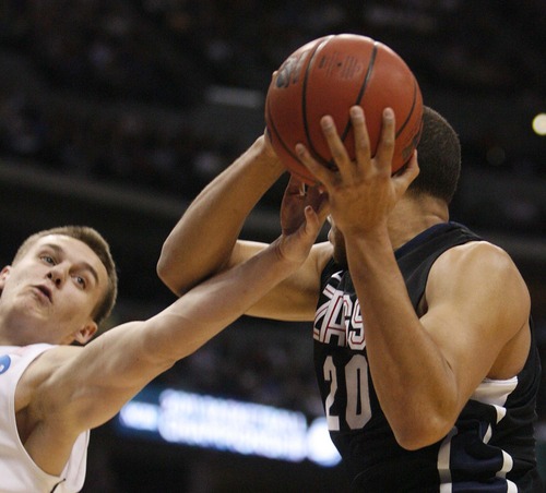 Trent Nelson  |  The Salt Lake Tribune
BYU's Kyle Collinsworth reaches in for the ball on Gonzaga's Elias Harris as BYU faces Gonzaga in the NCAA Tournament, men's college basketball at the Pepsi Center in Denver, Colorado, Saturday, March 19, 2011.