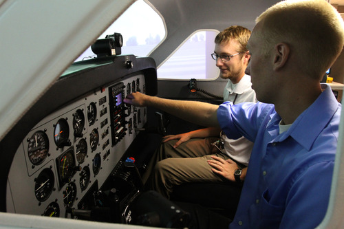Rick Egan  | The Salt Lake Tribune 

Flight Instructor Mike Manning (left) gives instructions to student Tyler Gaebe (right) while sitting in a flight simulator at Westminster College, Thursday, July 25, 2013.