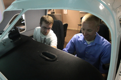 Rick Egan  | The Salt Lake Tribune 

Flight Instructor Mike Manning (left) gives instructions to student Tyler Gaebe (right) while sitting in a flight simulator at Westminster College, Thursday, July 25, 2013.