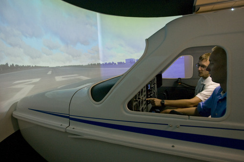 Rick Egan  | The Salt Lake Tribune 
Flight Instructor Mike Manning, left, gives instructions to student Tyler Gaebe, right, while sitting in a flight simulator at Westminster College, Thursday, July 25, 2013.