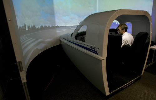 Rick Egan  | The Salt Lake Tribune 

Student Tyler Gaebe, (left) gets instructions from flight Instructor Mike Manning (right) while sitting in a flight simulator at Westminster College, Thursday, July 25, 2013.