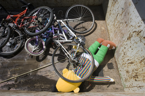 Rick Egan  | The Salt Lake Tribune 

A Bert doll is covered by unwanted bicycles in a garbage bin in Taylorsville, Friday, July 26, 2013. Taylorsville placed large garbage bins in each neighborhood for a day as part of the annual cleanup program.
