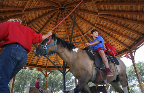 Scott Sommerdorf   |  The Salt Lake Tribune
A young visitor takes a ride on one of the horses at This Is the Place Heritage Park on Thursday. The park says it has improved animal care after being cited recently with violations of the federal Animal Welfare Act by the USDA.
