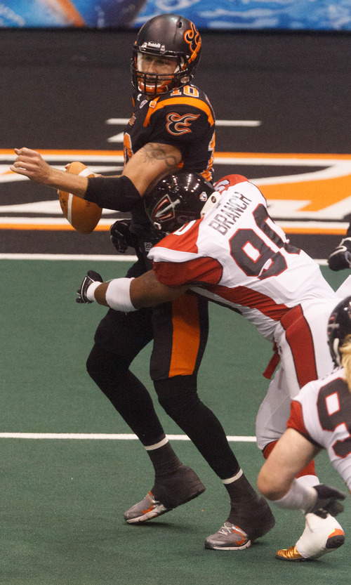 Trent Nelson  |  The Salt Lake Tribune
Cleveland's Darren Branch forces a fumble by Utah quarterback Tommy Grady as the Utah Blaze face the Cleveland Gladiators, AFL football at EnergySolutions Arena in Salt Lake City, Saturday July 27, 2013.