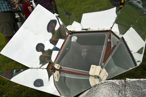Chris Detrick  |  The Salt Lake Tribune
Galen Schuck, of Sandy, talks about his sun oven during Solar Day at Liberty Park on Saturday.
