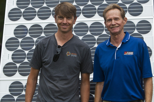 Chris Detrick  |  The Salt Lake Tribune
Toby Schmidt, of Creative Energies, and Alan Naumann, of Synergy Power, pose for a portrait in front of a 400 watt solar panel, which powered the festival, during Solar Day at Liberty Park Saturday July 27, 2013.
