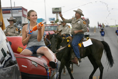 Scott Sommerdorf   |  The Salt Lake Tribune
Warm kids get sprayed during the International Days Parade in Price, Saturday, July 27, 2013.