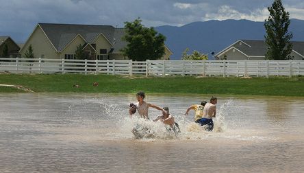 Scott Sommerdorf   |  The Salt Lake Tribune
Even as the next storm approaches, boys play football in the flooded baseball field in the Equestrian Pointe neighborhood of west Cedar City, Sunday, July 28, 2013.