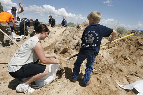 Scott Sommerdorf  |  The Salt Lake Tribune
Anjelica and Gavin Teter, of Cedar City, fill sandbags at the Iron County Search and Rescue center in Cedar City, Sunday, July 28, 2013.