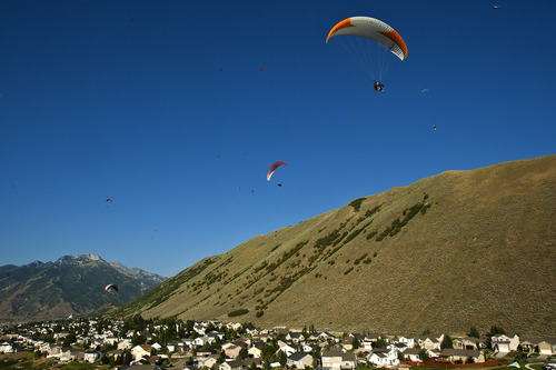 Chris Detrick  |  The Salt Lake Tribune
Paragliders fly over Steep Mountain near Geneva Rock Products in Draper Friday July 19, 2013.