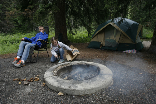 Francisco Kjolseth  |  The Salt Lake Tribune
Nicholas, 12, and Hailee, 6, Tronson of Lehi attend to camp while waiting for family to show up for a weekend of camping at the Spruces Campground near the top of Big Cottonwood Canyon. Back in 1905, the area served as a tree nursery to reforest the Wastach canyons and protect the watershed.
