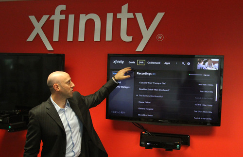 Rick Egan  | The Salt Lake Tribune 

Matthew Strauss, senior vice president of video services for Comcast, demonstrates the new interactive TV service allowing subscribers to put up multiple screens of info on the screen at the same time while watching TV, Thursday, July 25, 2013.  Utah is one of the first regions getting the service.