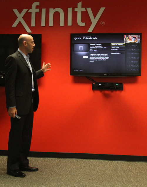 Rick Egan  | The Salt Lake Tribune 

Matthew Strauss, senior vice president of video services for Comcast, demonstrates the new interactive TV service allowing subscribers to put up multiple screens of info on the screen at the same time while watching TV, Thursday, July 25, 2013.  Utah is one of the first regions getting the service.